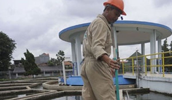 Seorang petugas saat membersihkan bak penampungan milik PDAM Tirta Mayang Jambi