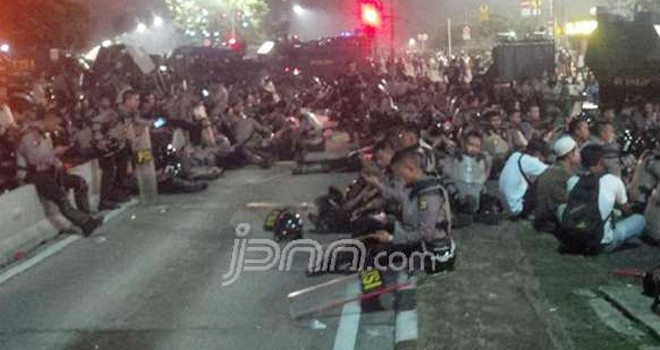Ratusan personel Brimob Polri melepas lelah, setelah massa Aksi Bela Islam II membubarkan diri, Jumat (4/11) sekitar pukul 21.00.â€Ž Foto: Fathan Sinaga/JPNN.com