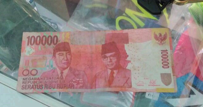 Terlihat upal yg diterima pemilik toko.
