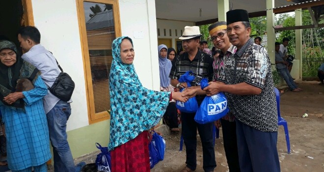 H Bakri membagikam  sembako kepada warga di Desa Tangkit Baru, Muaro Jambi.