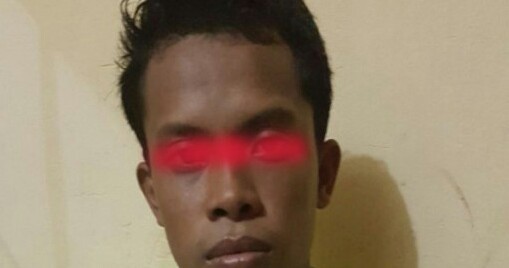 Tersangka saat diamankan polisi. 