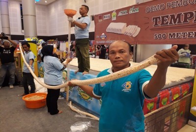 Proses pembuatan tempe sepanjang 500 meter yang dikerjakan 6 orang. (Aryo Mahendro/JawaPos.com)