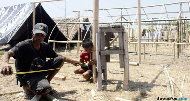 Warga membangun rumah hunian sementara di tanah lapang di Dusun Lekok Selatan, Desa Gondang, Kecamatan Gangga, Lombok Utara. (UMAR WIRAHADI/JAWA POS)