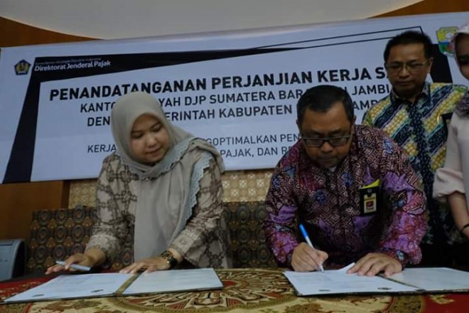 Bupati Masnah saat menandatangani MoU bersama Kakanwil DJP Sumbar-Jambi Ain Nursalim Saleh.