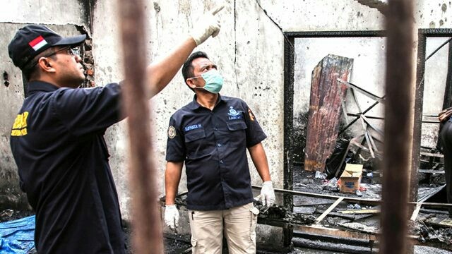 AMATI PUING: Petugas mencari bukti baru di pabrik macis di Binjai yang terbakar Jumat lalu (21/6). (Ivan Damanik/AFP). 