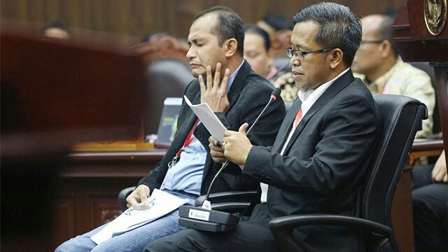 Ahli dari pihak terkait Prof Edward Omar Syarief Hiariej (kiri) dan Dr Heru Widodo (kanan) memberikan keterangan dalam sidang PHPU, di Gedung Mahkamah Konstitusi, Jakarta, Jumat (21/6). Sidang beragendakan mendengar keterangan saksi dan ahli dari pihak terkait, paslon nomor urut 01 Jokowi-Maruf Amin. (Miftahul Hayat/Jawa Pos)