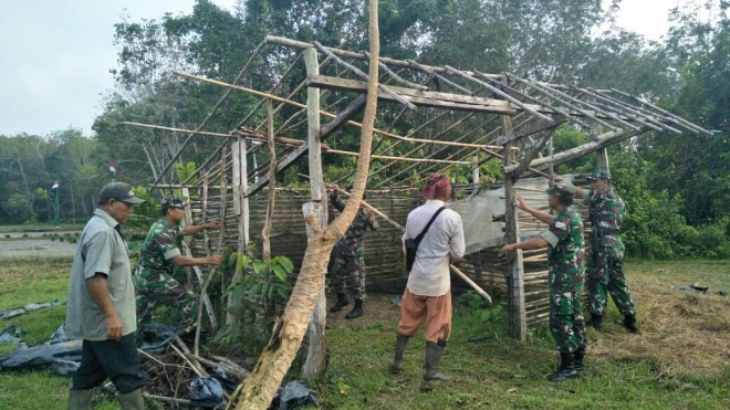 Babinsa ikut serta membantu memperbaiki pondok ladang milik petani, Sabtu (29/6/2019). 