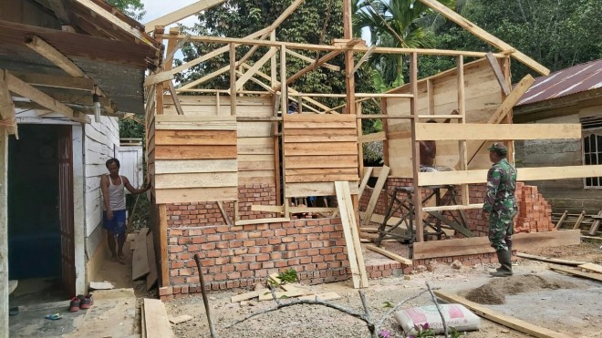 Babinsa Koramil 415-14/Muara Bulian, Sersan Satu Bambang Sutomo gotong royong bersama warga sekitar membangun rumah Juriani RT 06 Desa Ladang Peris. 