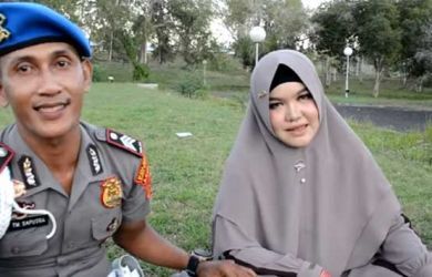 Brigadir TM Saputra bersama istrinya Maya Karmila.