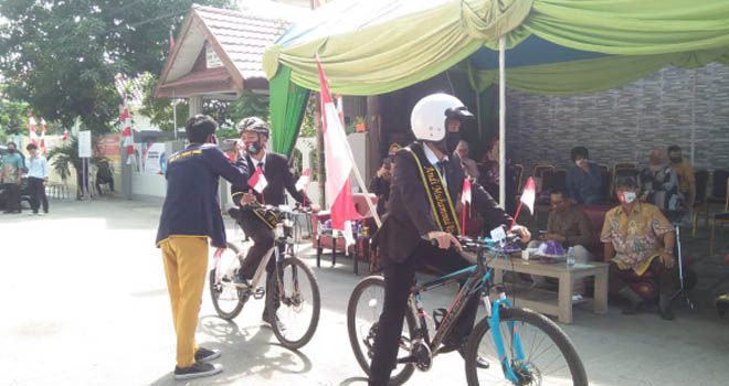 Unik… Pakai Sistem Drive Thru, Wisudawan Gunakan Sepeda