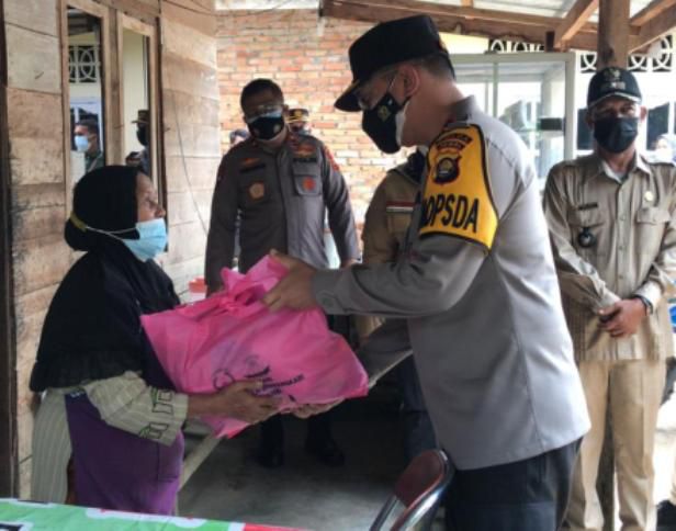 Kapolres Muarojambi AKBP Yuyan Priatmaja menyerahkan bantuan kepada warga