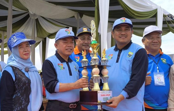 Gubernur Jambi, Dr. H. Alharis, menyerahkan piala juara umum 2 untuk kabupaten Bungo dalam kegiatan HKP ke 52.