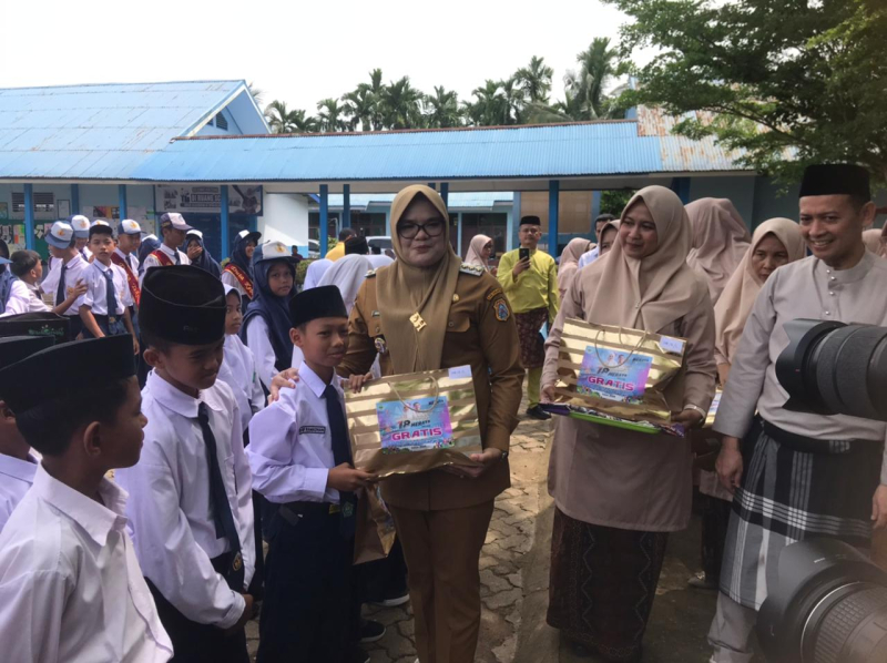 Bupati Tanjabtim, Dillah Hikmah Sari menyerahkan bantuan program seragam sekolah kepada siswa